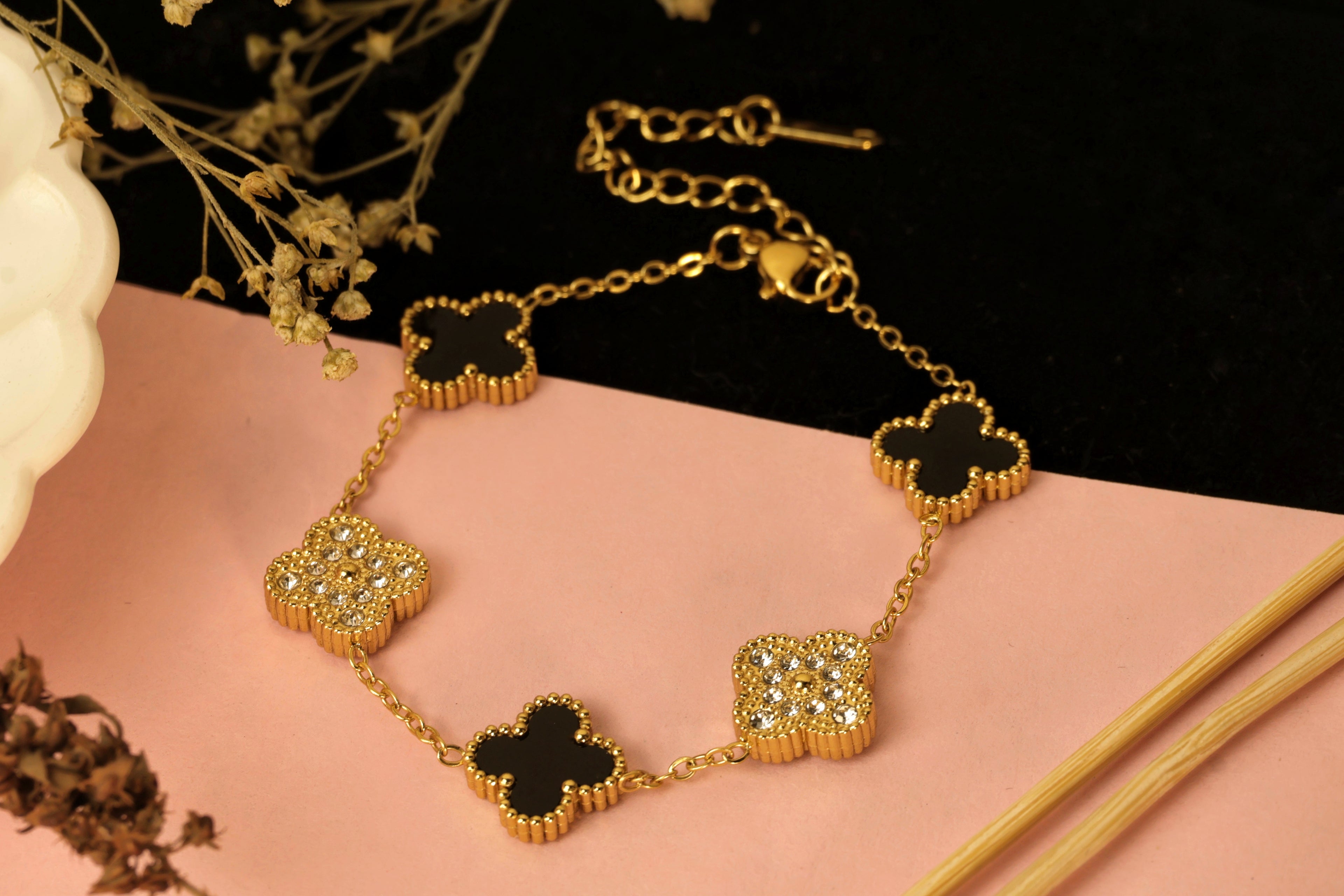 Lucky Charm Bracelet - gold chain with various gold and black clover charms